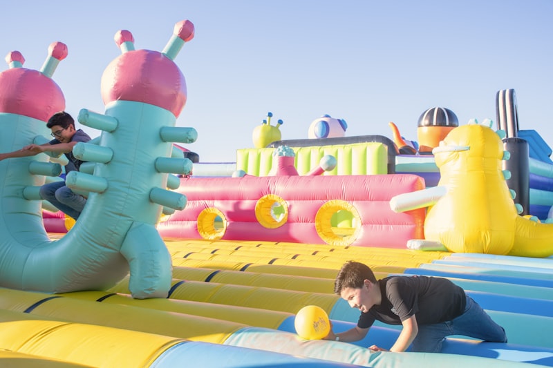 Kids playing on a colorful inflatable obstacle course